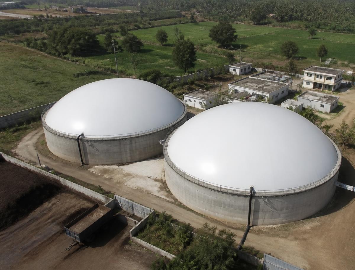Aerial view of dome-roofed anaerobic digester tanks at a BioCNG plant